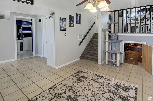 4958 S 3900 W, Roy, UT 84067 - stairs featuring ceiling fan, tile patterned floors, baseboards, and a textured ceiling