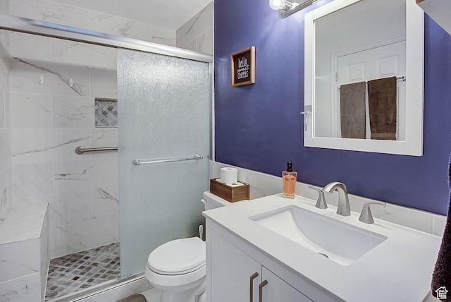 bathroom featuring walk in shower, vanity, and toilet