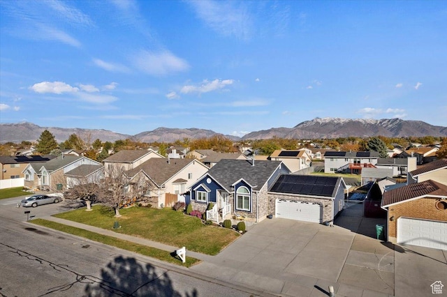 4958 S 3900 W, Roy, UT 84067 - view of front facade featuring a residential view, an attached garage, a mountain view, and concrete driveway