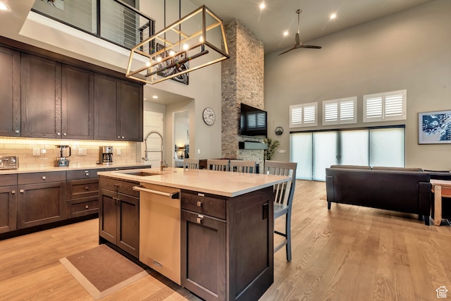 10005 N Meer Cir, Heber City, UT 84032 - kitchen with a towering ceiling, sink, a breakfast bar area, a kitchen island with sink, and stainless steel dishwasher