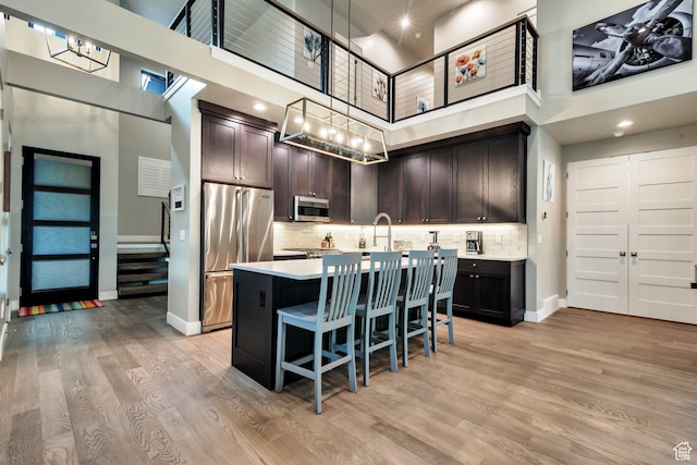 10005 N Meer Cir, Heber City, UT 84032 - kitchen with stainless steel appliances, a high ceiling, a center island with sink, and pendant lighting