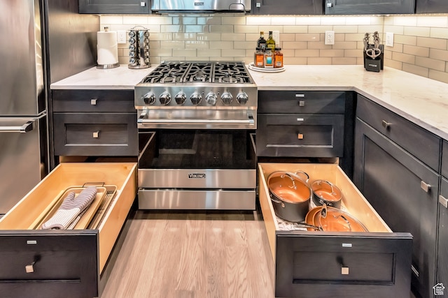 10005 N Meer Cir, Heber City, UT 84032 - kitchen with decorative backsplash, stainless steel appliances, light hardwood / wood-style floors, and light stone countertops