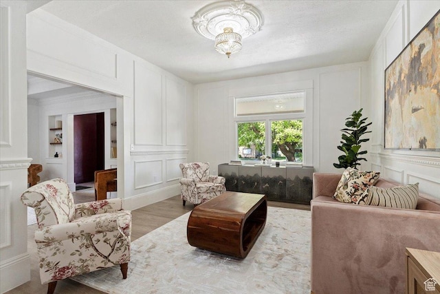 855 S 700 E, Salt Lake City, UT 84102 - living area featuring a decorative wall, light wood finished floors, and a chandelier