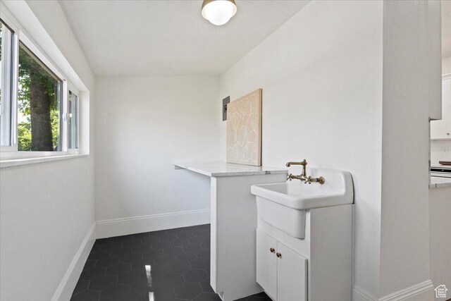 855 S 700 E, Salt Lake City, UT 84102 - laundry room with a sink, baseboards, and dark tile patterned flooring
