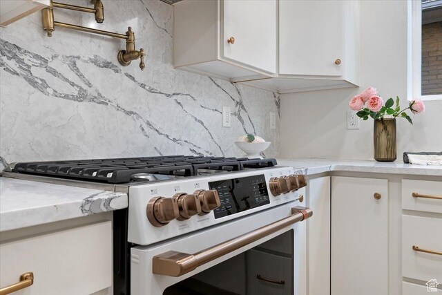 855 S 700 E, Salt Lake City, UT 84102 - kitchen featuring white range with gas stovetop, light countertops, backsplash, and white cabinetry