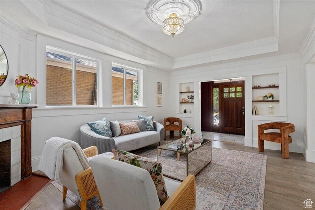 855 S 700 E, Salt Lake City, UT 84102 - living room with built in features, ornamental molding, a chandelier, wood finished floors, and a tray ceiling