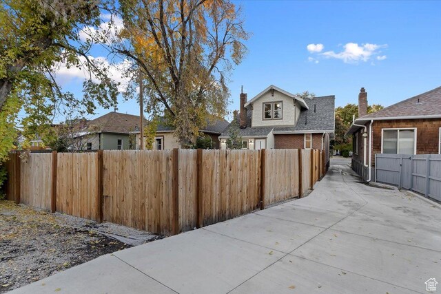 855 S 700 E, Salt Lake City, UT 84102 - view of side of home with fence, a chimney, and brick siding