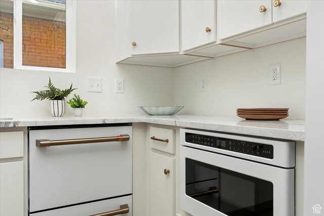 855 S 700 E, Salt Lake City, UT 84102 - kitchen with white appliances, white cabinetry, and light countertops