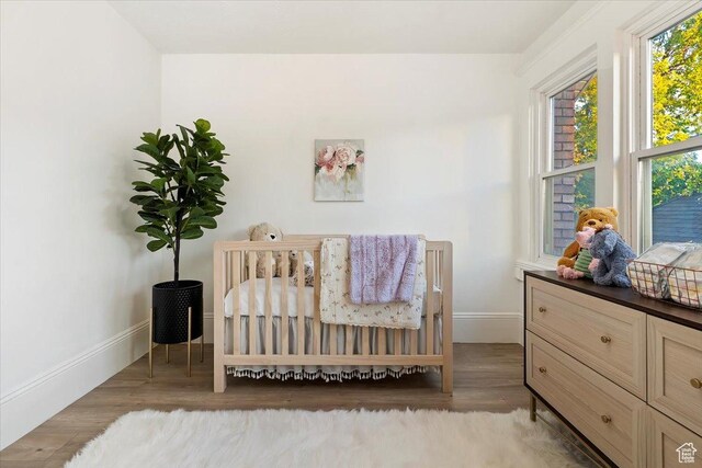855 S 700 E, Salt Lake City, UT 84102 - bedroom featuring wood finished floors, baseboards, and a nursery area