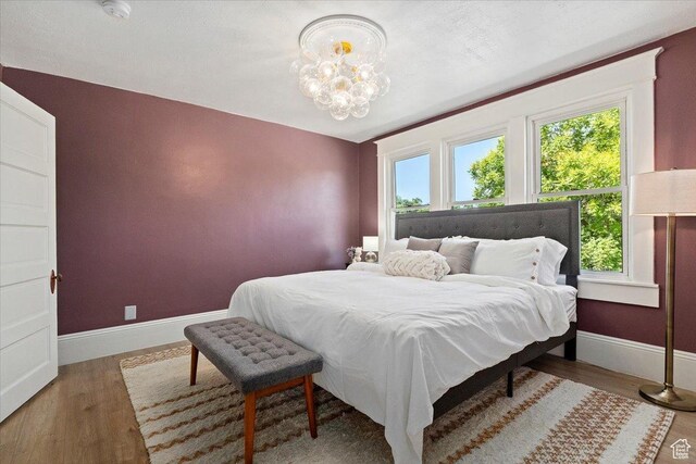 855 S 700 E, Salt Lake City, UT 84102 - bedroom with wood finished floors, a chandelier, and baseboards