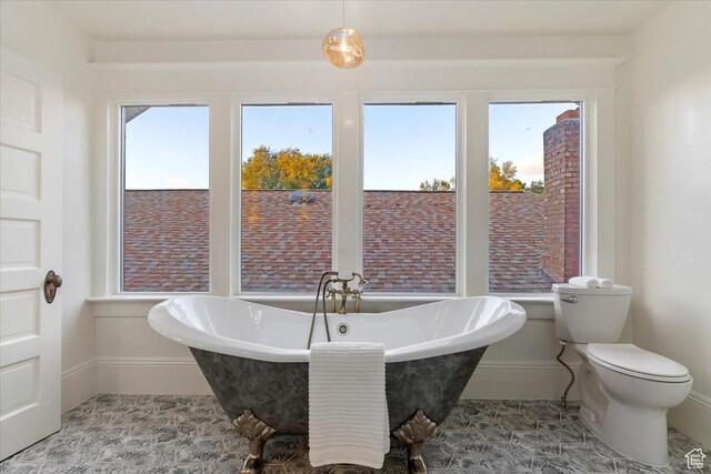 855 S 700 E, Salt Lake City, UT 84102 - bathroom with baseboards, a freestanding tub, and toilet