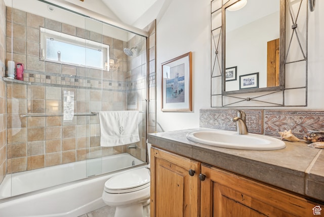 full bathroom with vanity, shower / bath combination with glass door, lofted ceiling, decorative backsplash, and toilet