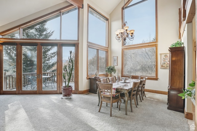 sunroom featuring lofted ceiling and an inviting chandelier