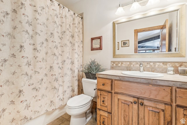 bathroom featuring tile patterned floors, vanity, and toilet