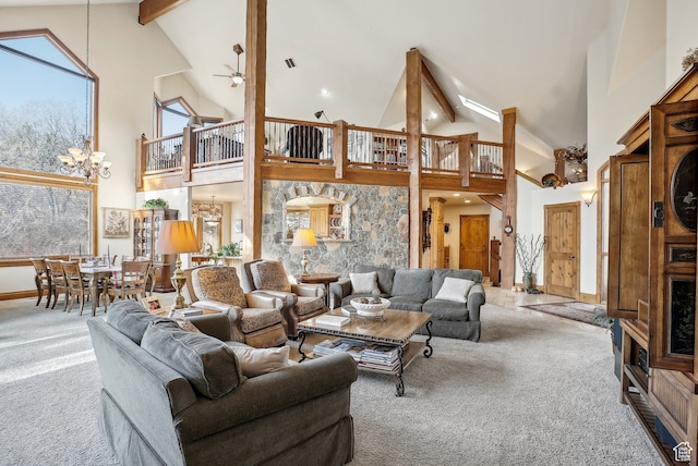 carpeted living room featuring beamed ceiling, ceiling fan with notable chandelier, and high vaulted ceiling