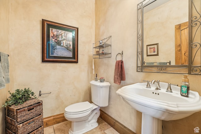 bathroom with tile patterned flooring, toilet, and sink