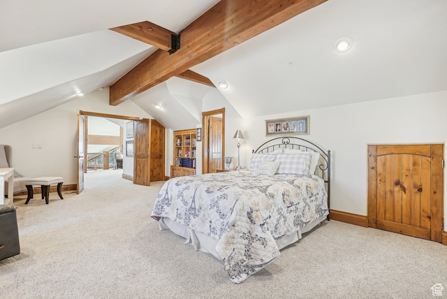 carpeted bedroom featuring lofted ceiling with beams