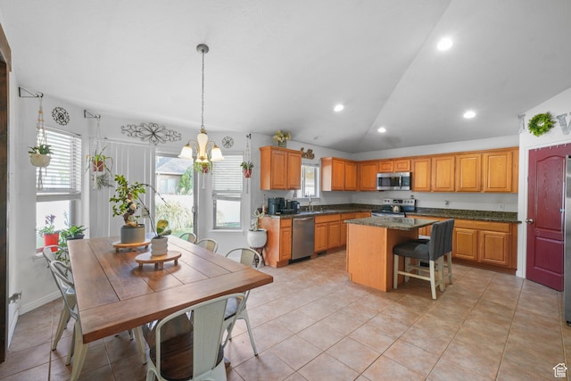 1567 S 1700 E, Spanish Fork, UT 84660 - kitchen with stainless steel appliances, lofted ceiling, hanging light fixtures, a kitchen island, and dark stone countertops