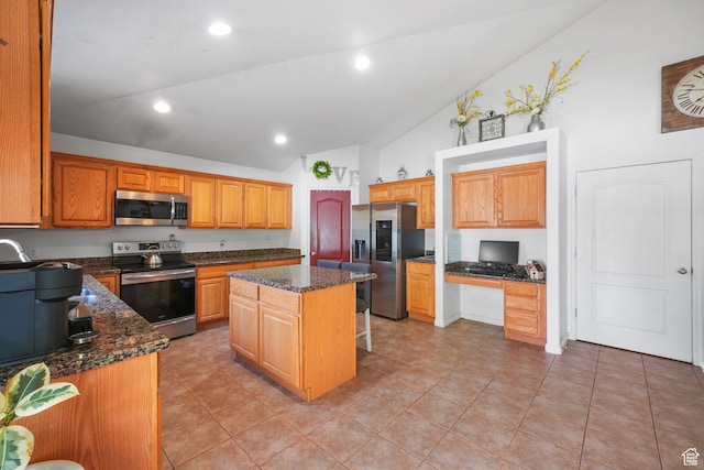 1567 S 1700 E, Spanish Fork, UT 84660 - kitchen with stainless steel appliances, light tile patterned flooring, dark stone counters, and a center island