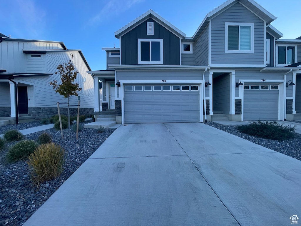 1778 E Eagle View Ln, Eagle Mountain, UT 84005 - view of front of home featuring an attached garage, driveway, and board and batten siding
