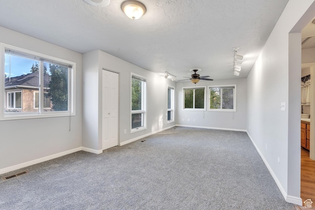 3635 S Arbor Park Dr, Magna, UT 84044 - spare room featuring carpet flooring, ceiling fan, a textured ceiling, and baseboards