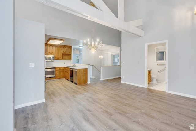3635 S Arbor Park Dr, Magna, UT 84044 - kitchen with appliances with stainless steel finishes, a chandelier, high vaulted ceiling, baseboards, and light countertops