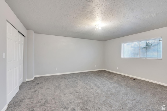 3635 S Arbor Park Dr, Magna, UT 84044 - unfurnished bedroom featuring a textured ceiling, carpet flooring, baseboards, and a closet