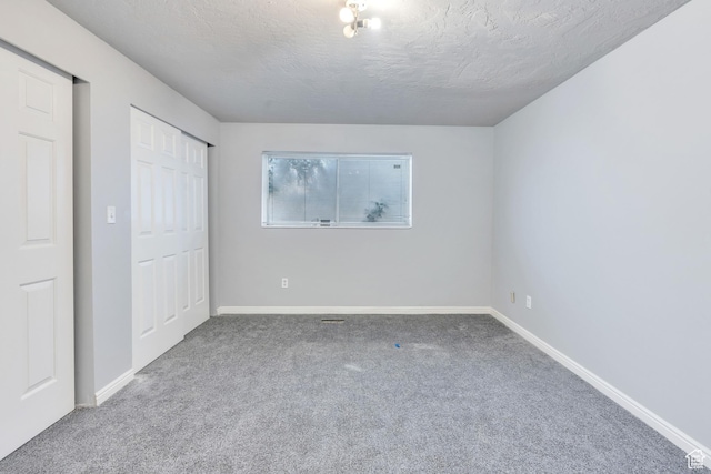 3635 S Arbor Park Dr, Magna, UT 84044 - unfurnished bedroom with carpet, baseboards, a textured ceiling, and a closet