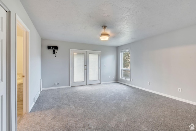 3635 S Arbor Park Dr, Magna, UT 84044 - carpeted spare room with french doors, baseboards, and a textured ceiling