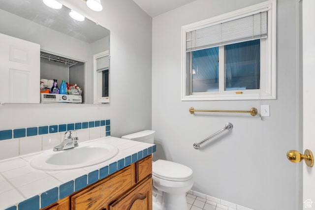 3635 S Arbor Park Dr, Magna, UT 84044 - half bath with toilet, vanity, decorative backsplash, tile patterned flooring, and baseboards