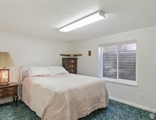 180 N 1100 E Unit 133, Washington, UT 84780 - bedroom featuring a textured ceiling, baseboards, and carpet floors