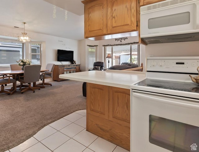 180 N 1100 E Unit 133, Washington, UT 84780 - kitchen featuring white appliances, open floor plan, light countertops, light tile patterned floors, and light colored carpet