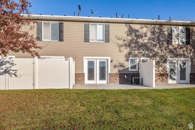 back of house featuring a lawn, cooling unit, a patio, and french doors