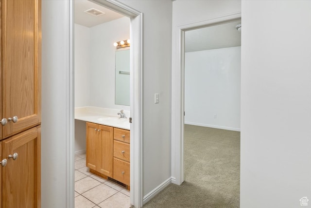 bathroom featuring tile patterned flooring and vanity