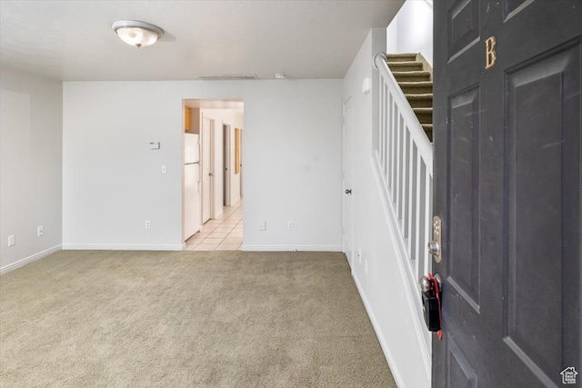 unfurnished room featuring light carpet