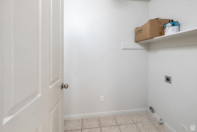 laundry room featuring hookup for an electric dryer, light tile patterned flooring, and hookup for a gas dryer