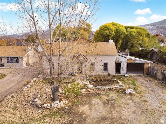 165 S 200 W, Manti, UT 84642 - view of front of house featuring a mountain view, a carport, dirt driveway, and a chimney