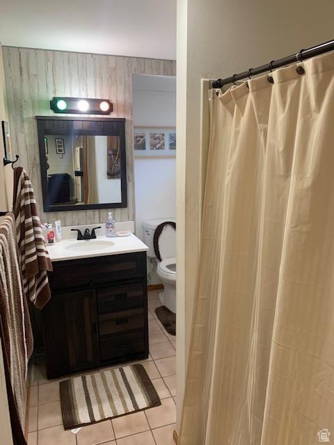 bathroom with walk in shower, tile patterned flooring, vanity, and toilet