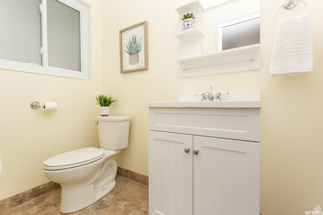 bathroom with toilet and vanity