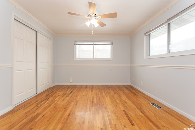 unfurnished bedroom with ornamental molding, light hardwood / wood-style floors, and a closet