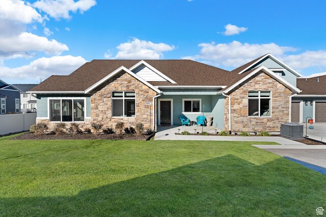 519 N Pintail Ln Unit C, Vineyard, UT 84059 - craftsman inspired home featuring stone siding, a shingled roof, central air condition unit, and stucco siding