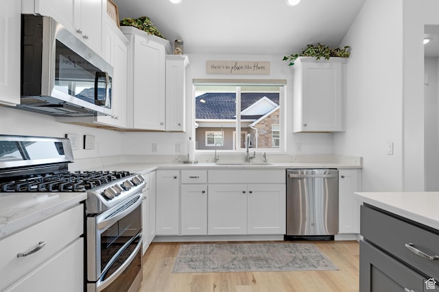 519 N Pintail Ln Unit C, Vineyard, UT 84059 - kitchen featuring stainless steel appliances, a sink, light wood-style floors, white cabinets, and recessed lighting