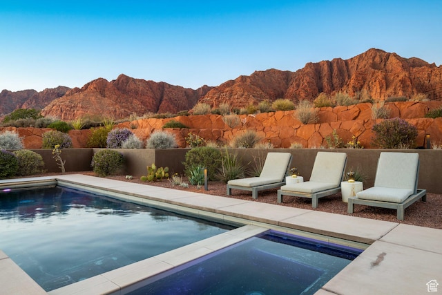 1748 N Cochise Dr, Ivins, UT 84738 - view of swimming pool with an in-ground hot tub and a mountain view