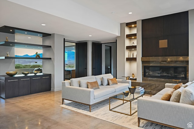 1748 N Cochise Dr, Ivins, UT 84738 - living room featuring built in shelves, a fireplace, concrete floors, baseboards, and recessed lighting