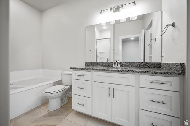 bathroom featuring a garden tub, vanity, toilet, and tile patterned floors