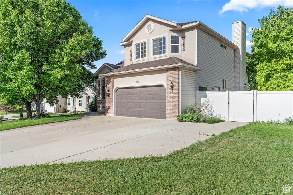 1617 N 350 E, Layton, UT 84041 - view of side of property featuring brick siding, a garage, driveway, and a chimney