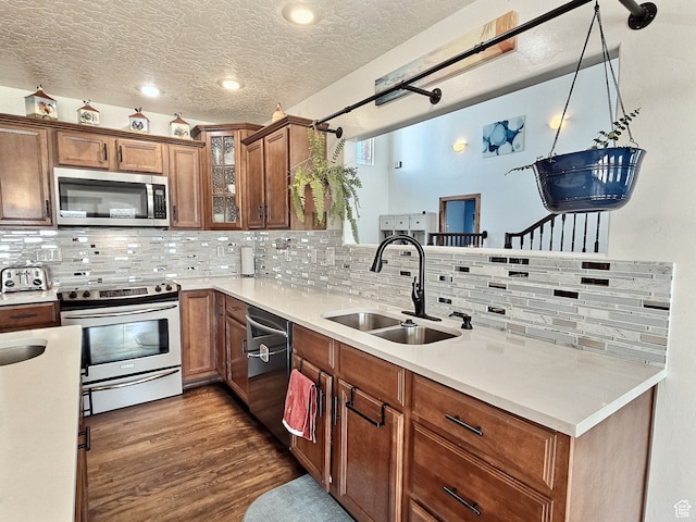 660 S 2500 W, Vernal, UT 84078 - kitchen with sink, decorative backsplash, a textured ceiling, appliances with stainless steel finishes, and decorative light fixtures