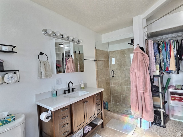 660 S 2500 W, Vernal, UT 84078 - bathroom featuring vanity, tile patterned floors, toilet, a textured ceiling, and walk in shower