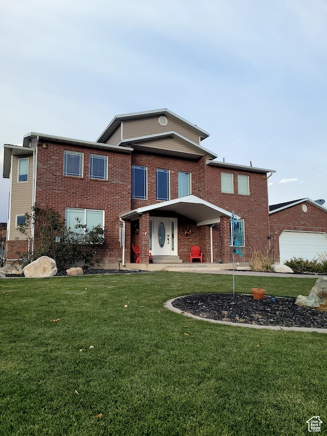 view of front of property with a front yard and a garage