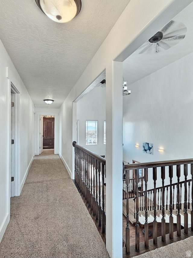 660 S 2500 W, Vernal, UT 84078 - hallway featuring carpet flooring, a textured ceiling, and a chandelier